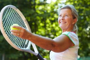 senior woman playing tennis